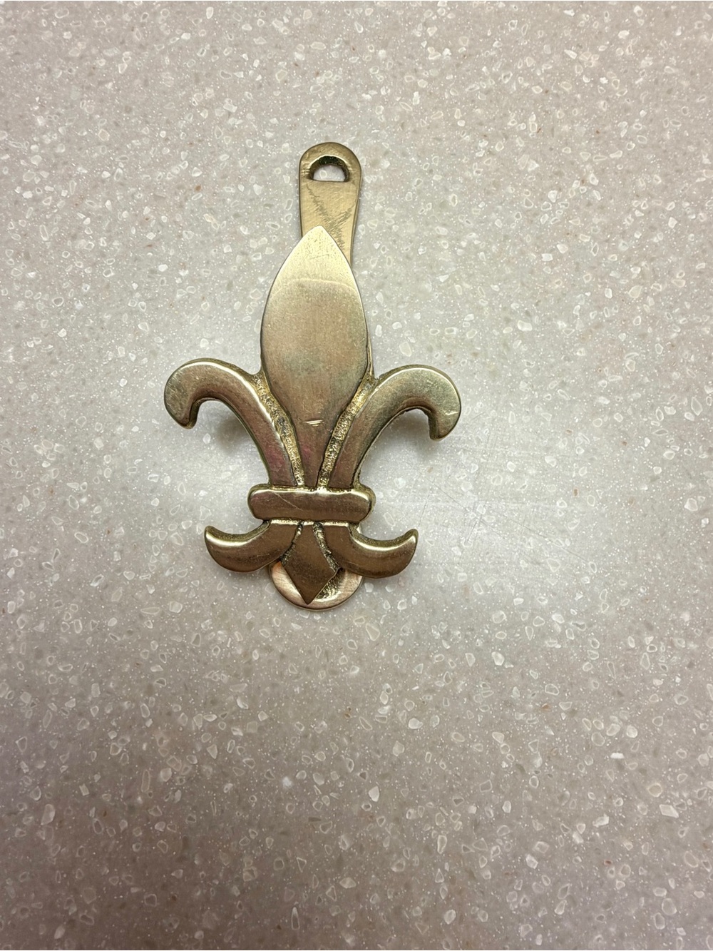 Vintage, brass and handmade fleur de lis clip.